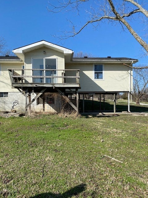 A house with a balcony is surrounded by grass and trees.