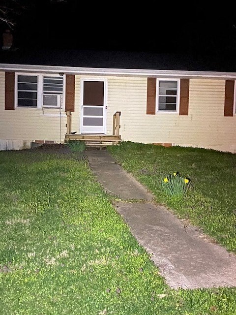 A small white door is on the side of a house.