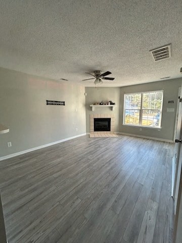 A living room with a fireplace and a ceiling fan.