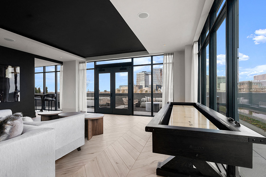 a living room with a pool table and a view of the city