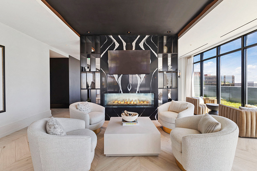 a living room with white furniture and a fireplace