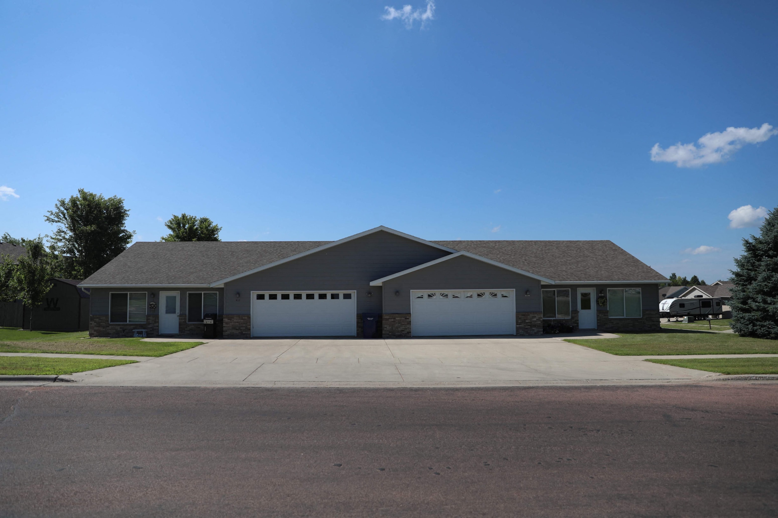 a large house with a driveway and garage doors