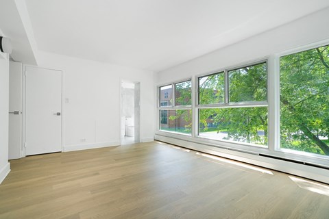 a living room with a large window and wood floors