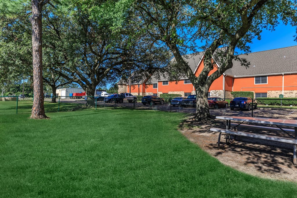 a park with a picnic table in front of a building