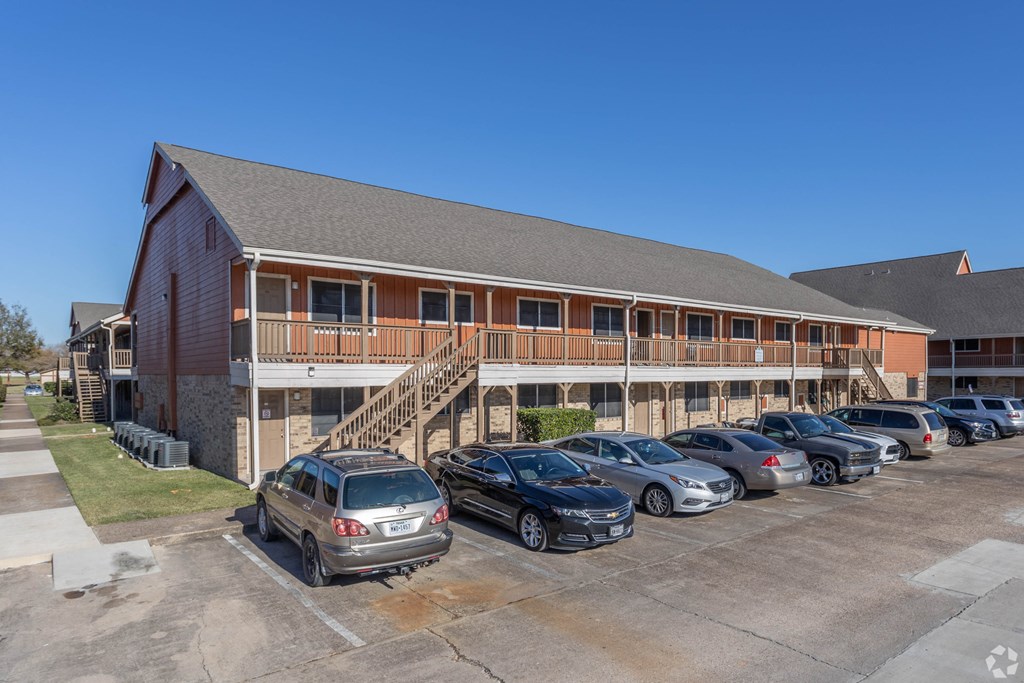 an office building with cars parked in front of it