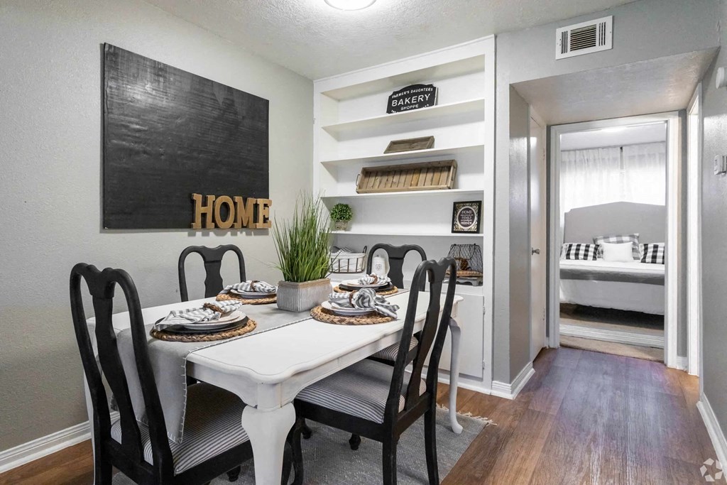 a dining room with a white table and chairs
