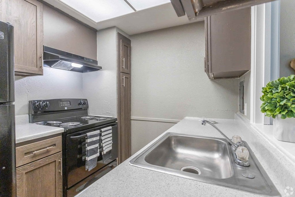 a kitchen with a sink and a stove
