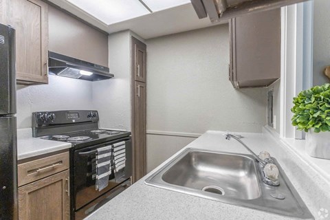 a kitchen with a sink and a stove