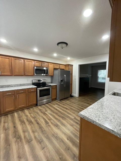 A kitchen with wooden cabinets and stainless steel appliances.