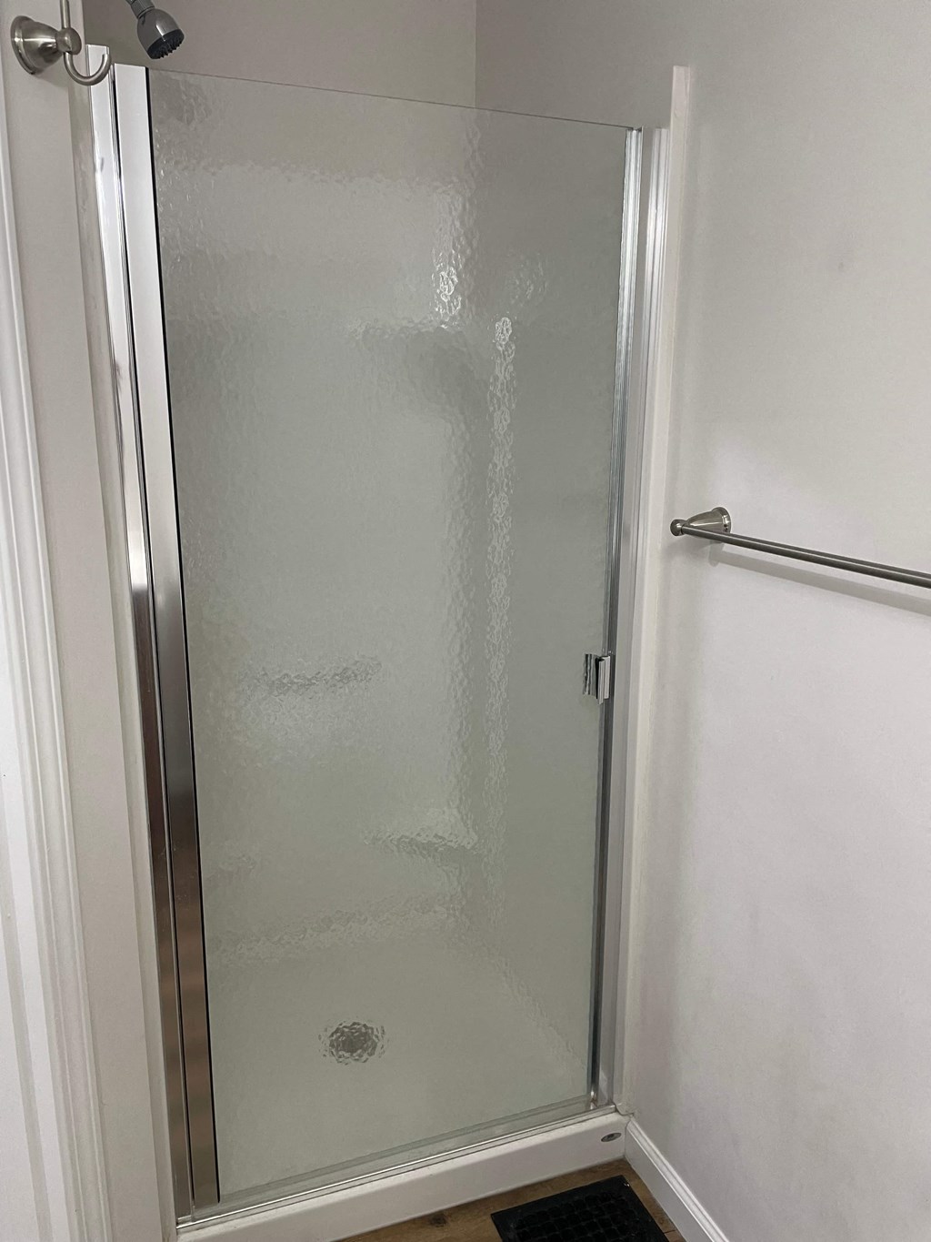 a shower with a glass door in a bathroom