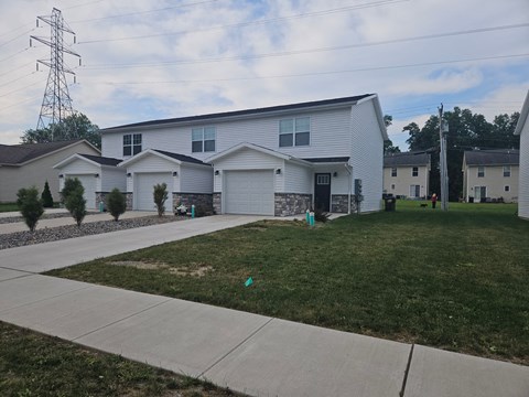 a white house with a sidewalk in front of it