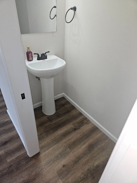a small bathroom with a sink and a mirror