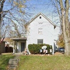 a white house with a yard in front of it