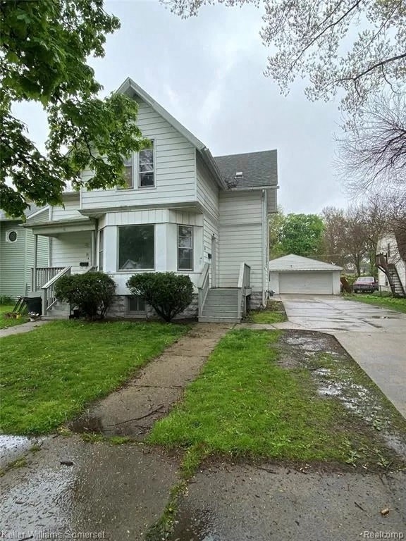 a white house with a sidewalk in front of it