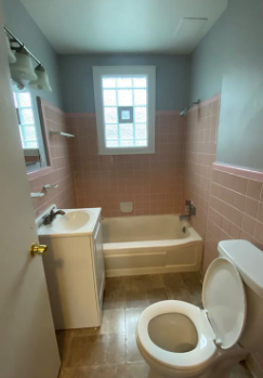 a bathroom with a toilet and a sink and a bath tub
