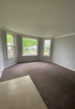 an empty living room in a house with windows
