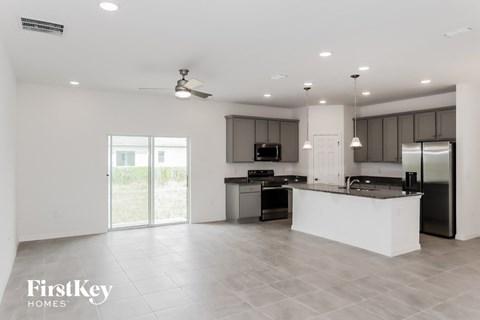 an open kitchen with a large island and stainless steel appliances