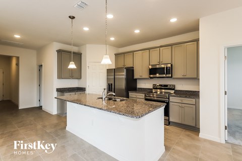 a kitchen with granite counter tops and stainless steel appliances