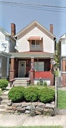A house with a red door and a brick chimney.