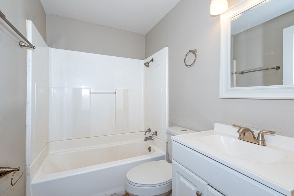 a bathroom with a sink toilet and a tub