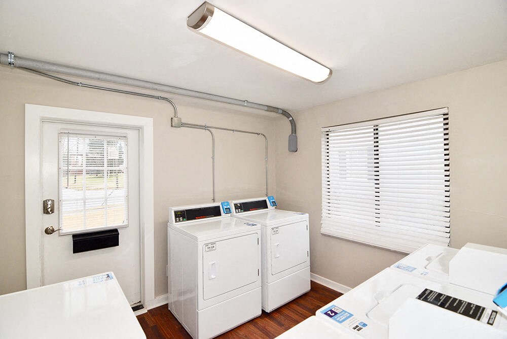 a small laundry room with two washes and a dryer
