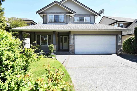 a house with a white garage door and a driveway