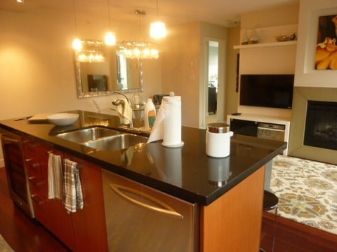 a kitchen with a black counter top and a sink