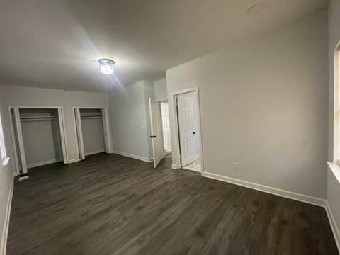 a living room with gray walls and a wooden floor