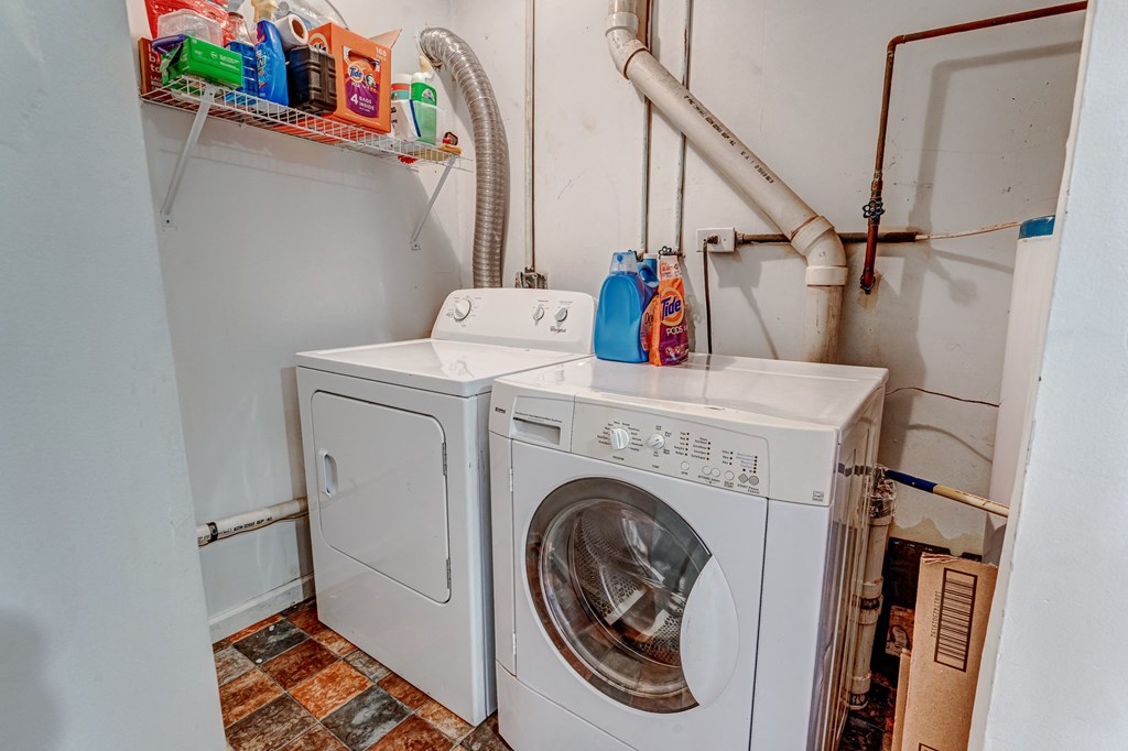 A white washing machine and dryer in a small laundry room.