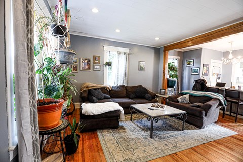 A living room with a brown couch and a coffee table.