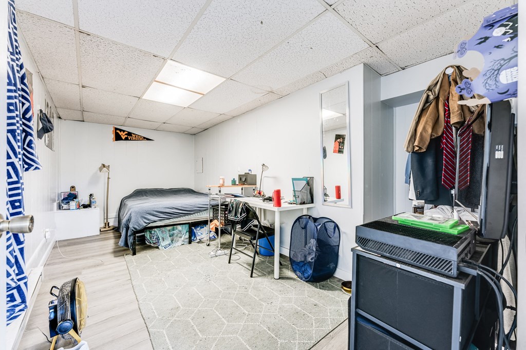 A room with a bed, desk, and chair.