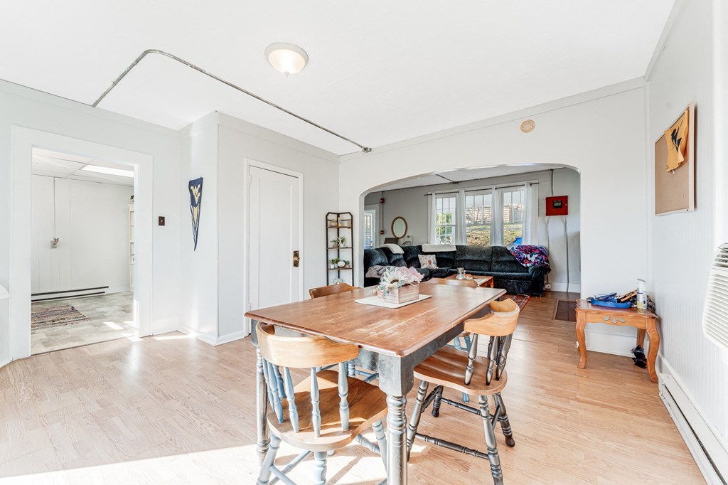 A dining room with a wooden table and chairs.