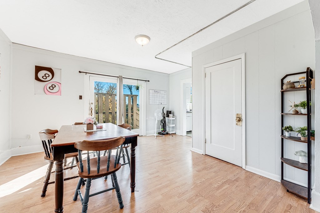 A dining room with a table and chairs.
