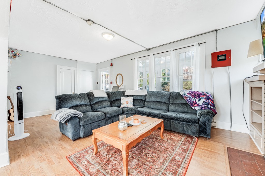 A living room with a grey sofa and a wooden coffee table.