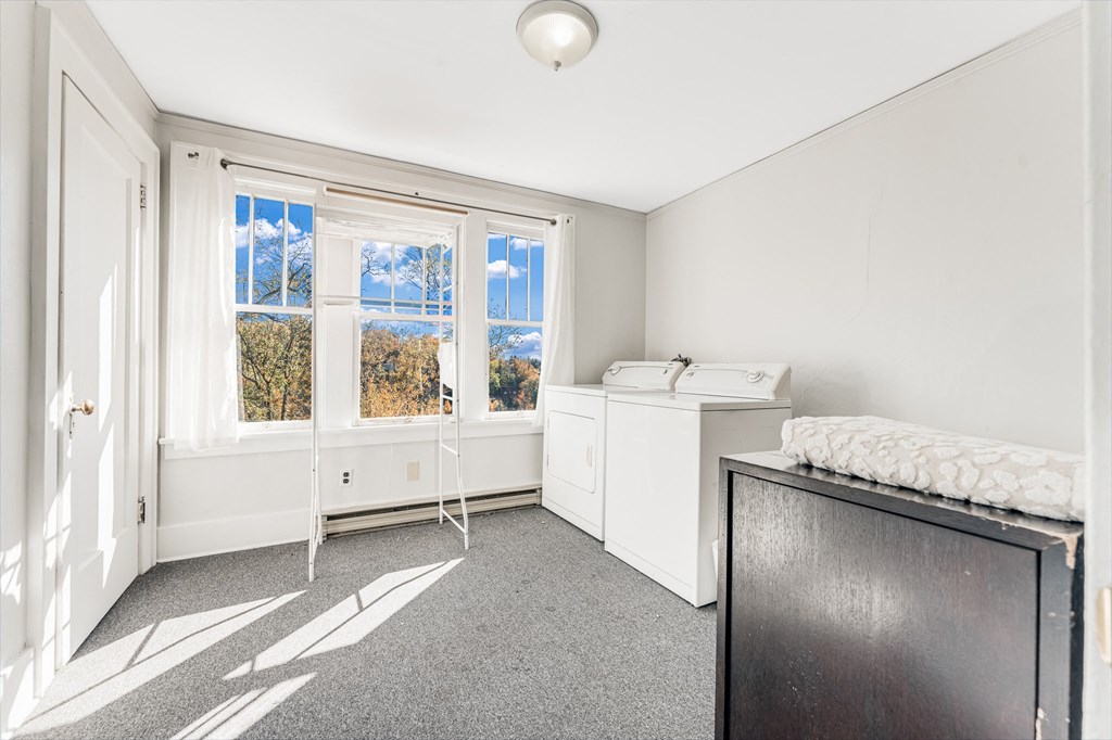 A room with a window overlooking trees.