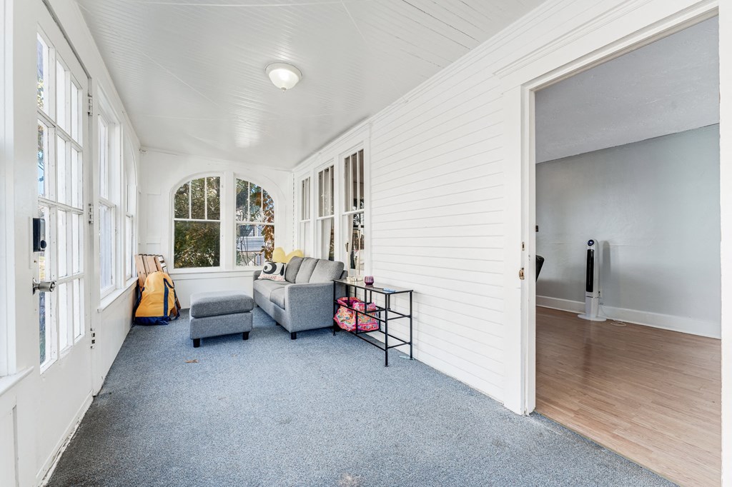 A room with a grey sofa.
