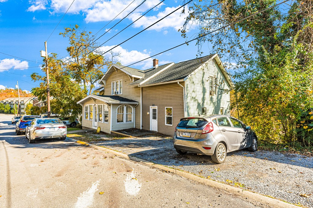 A house with a car parked in front of it.