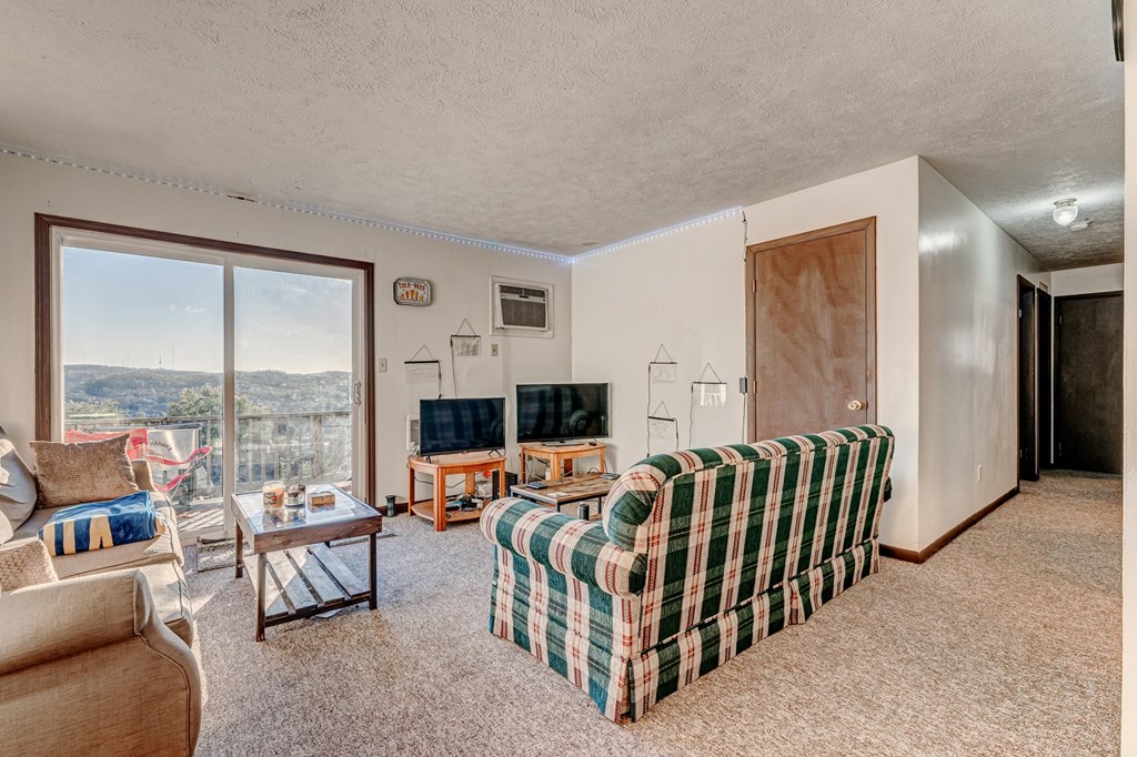 A living room with a couch, chair, and a coffee table.