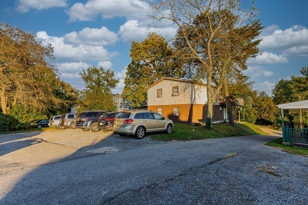 A parking lot with cars and a building in the background.