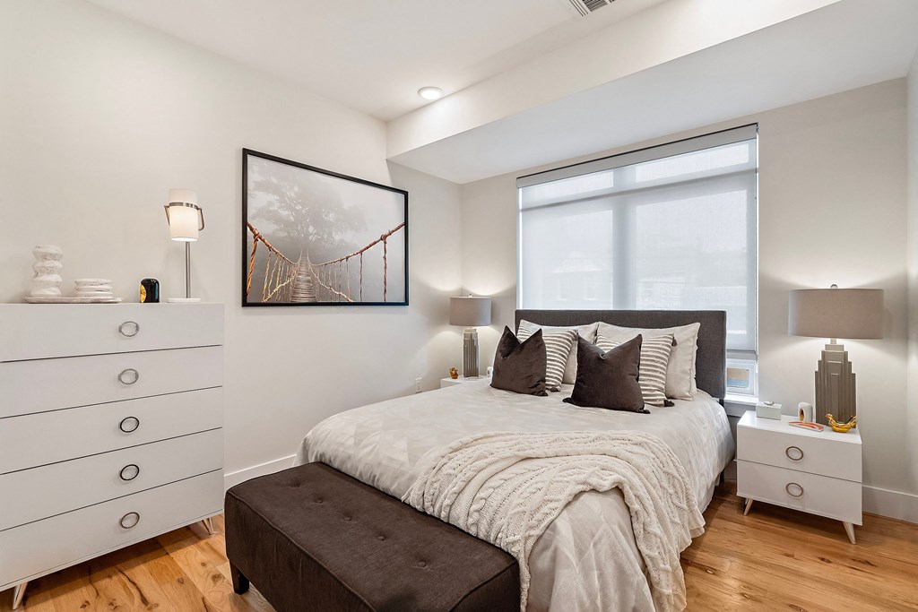 a bedroom with a bed and a large window
