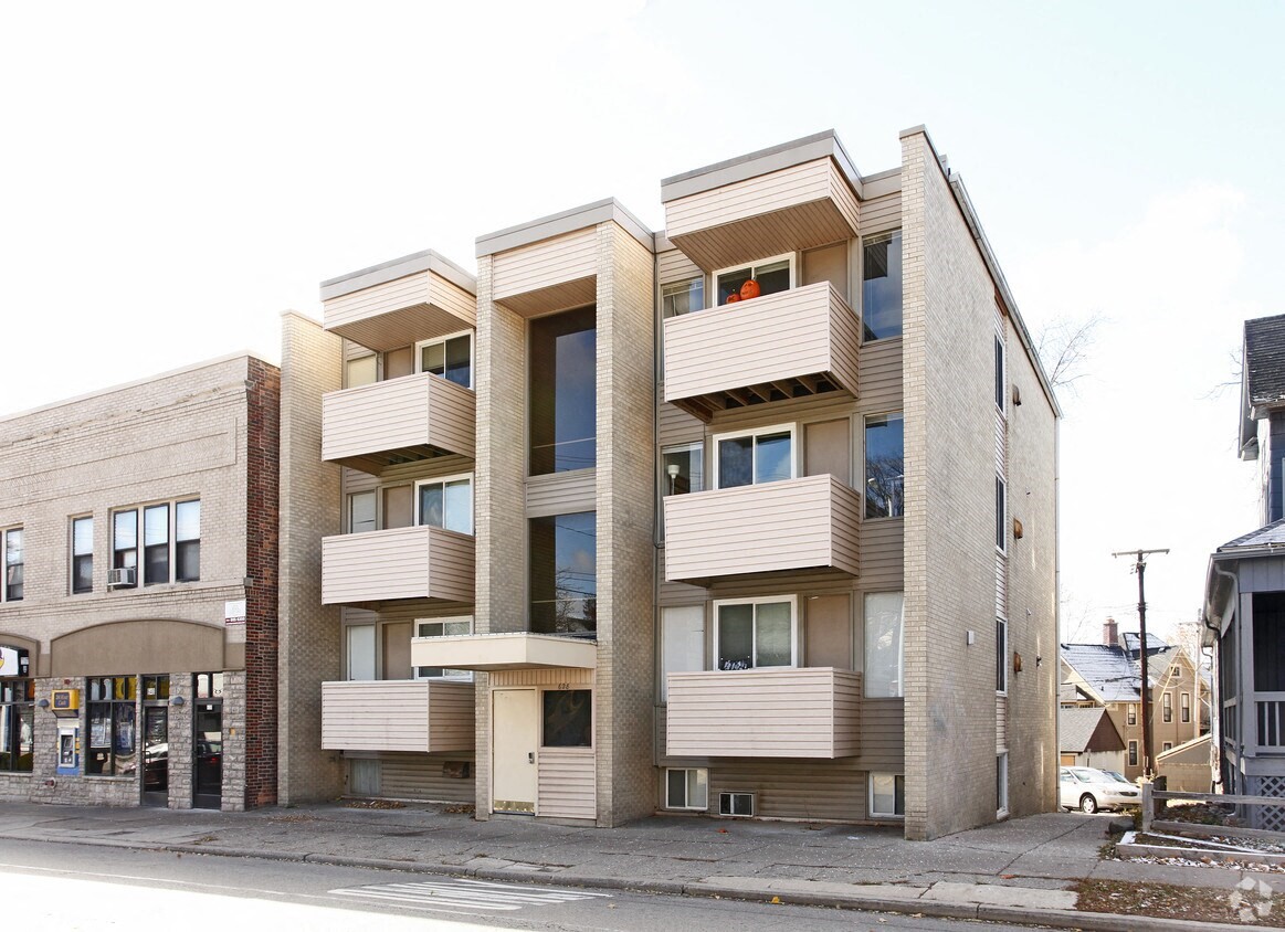 a building with balconies and a street in front of it