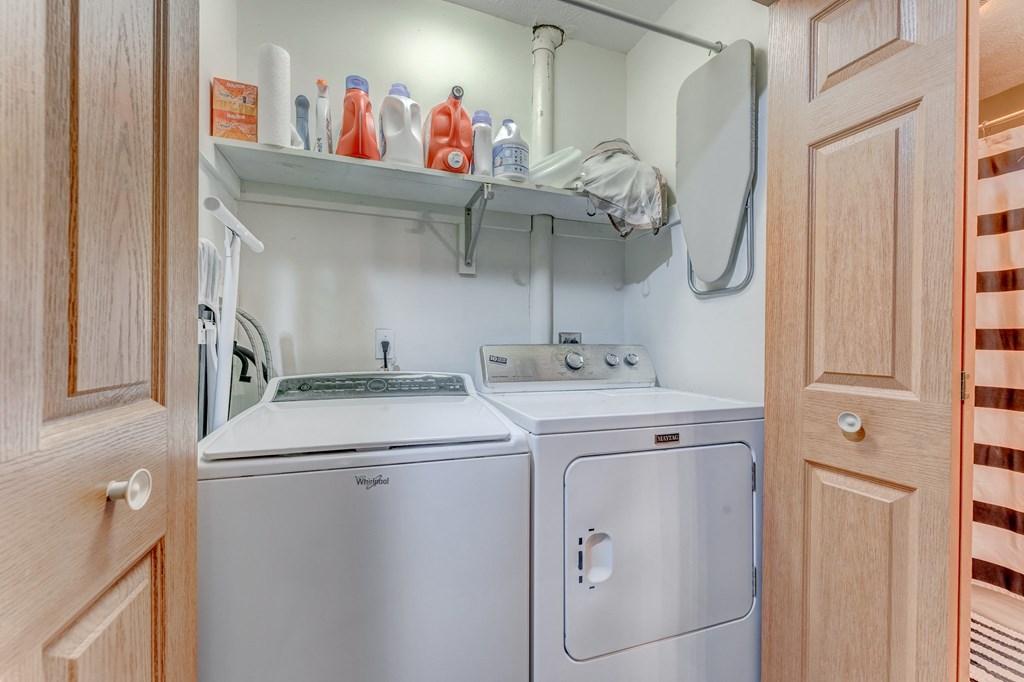 A small laundry room with a washer and dryer.
