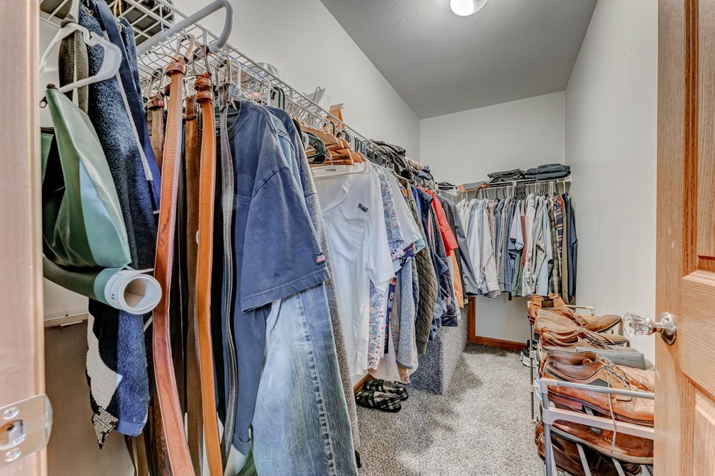 A room full of clothes hanging on racks.