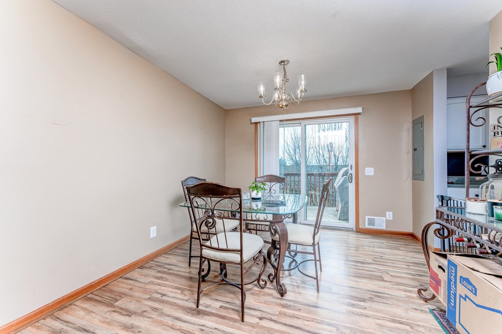 A dining room with a table and chairs.