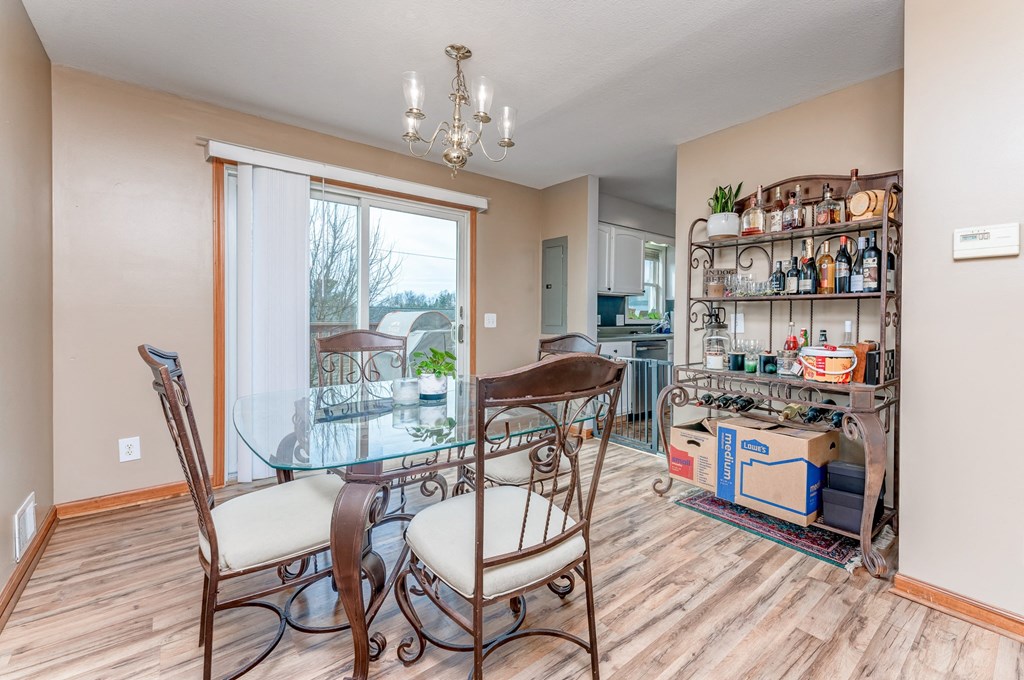 A dining room with a glass table and chairs.