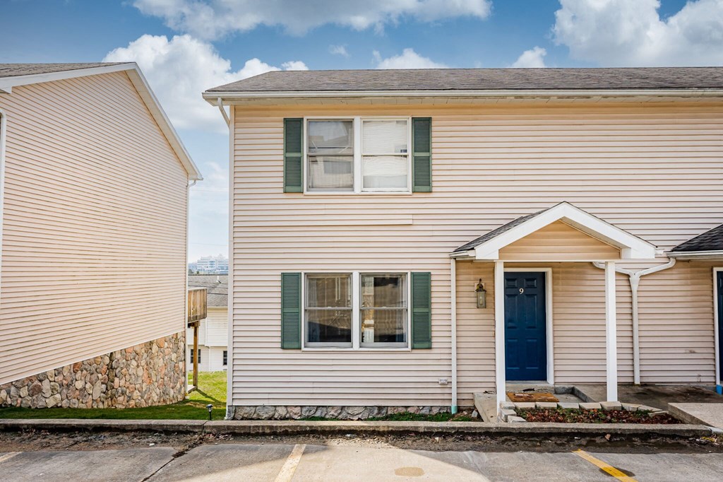 A house with a blue door and green shutters.