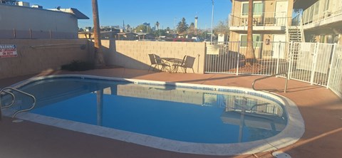A small pool with a concrete floor and a concrete wall.