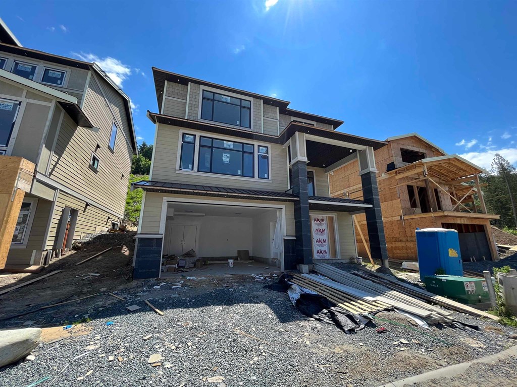 a house under construction with a garage in front of it
