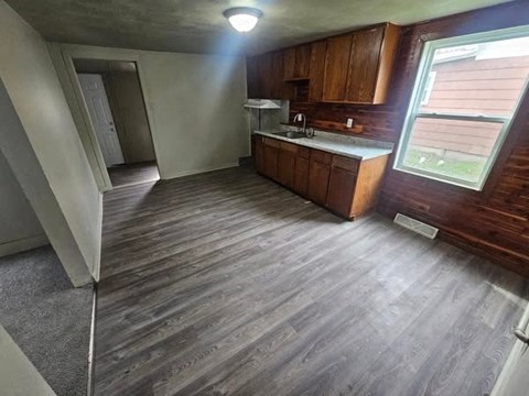 A room with wooden flooring and a window.