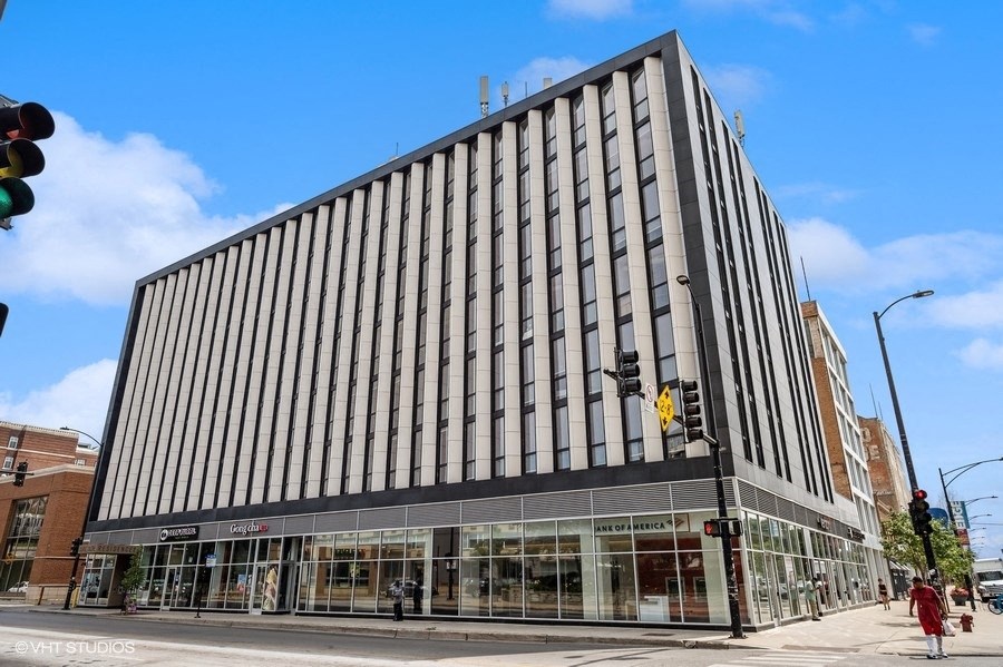 a tall building on the corner of a city street
